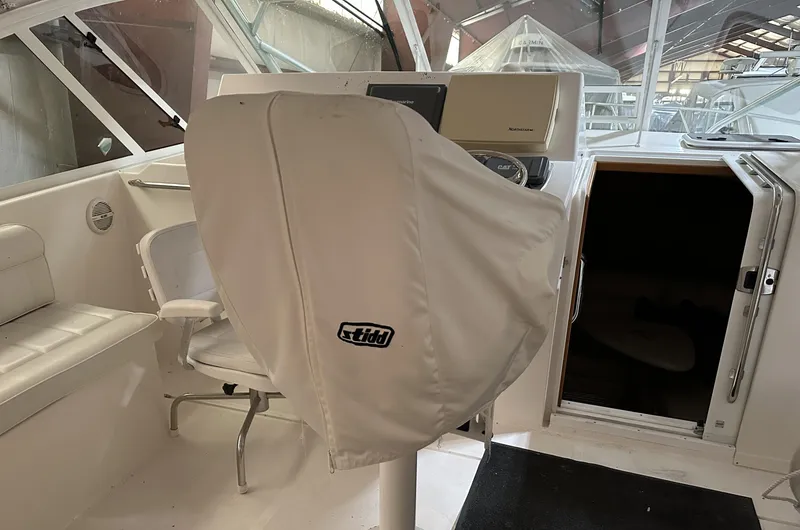 Slide: The Image of 2006 Cabo 40 Express boat interior with covered helm and seating area. - 13