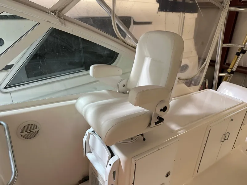 Slide: The Image of Captain's chair on 2006 Cabo 40 Express yacht, white interior, helm station view. - 15