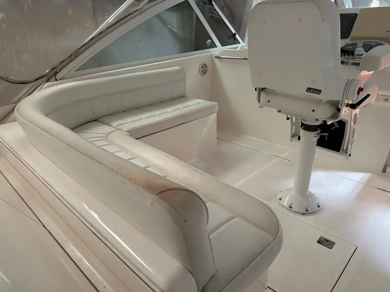 Slide: The Image of 2006 Cabo 40 Express boat interior with white seating and helm chair. - 16