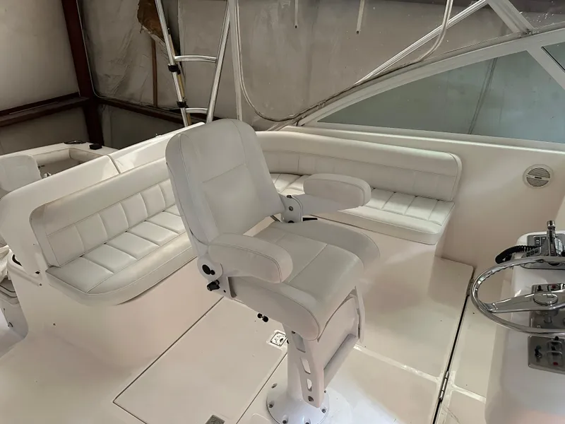 Slide: The Image of 2006 Cabo 40 Express boat interior with white seating and helm chair. - 17