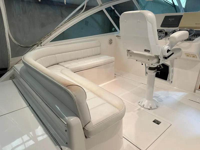Slide: The Image of 2006 Cabo 40 Express boat interior with white seating and helm station. - 18