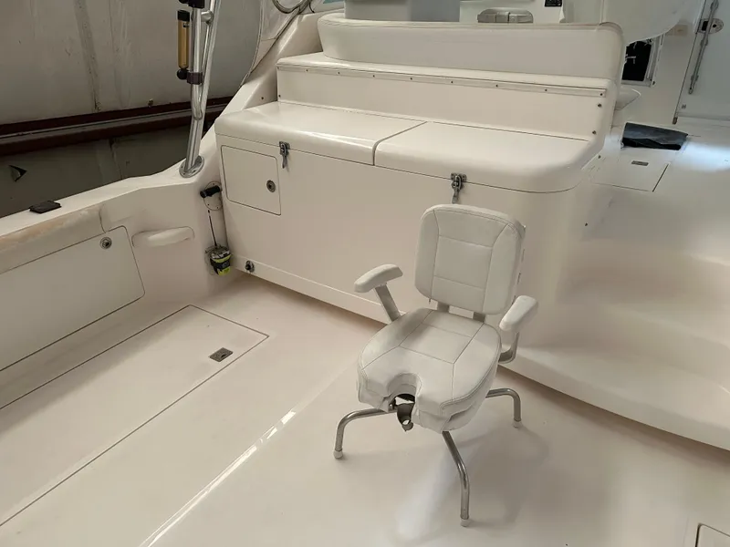 Slide: The Image of 2006 Cabo 40 Express boat interior with white seating and storage compartments. - 19