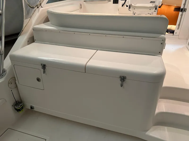 Slide: The Image of 2006 Cabo 40 Express boat interior with white seating and storage compartments. - 21