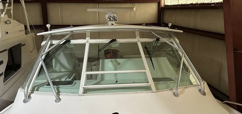 Slide: The Image of 2006 Cabo 40 Express boat in storage, front view with windshield and wipers. - 22