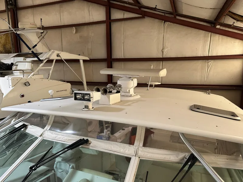 Slide: The Image of 2006 Cabo 40 Express boat in storage, featuring radar and navigation equipment on the roof. - 23