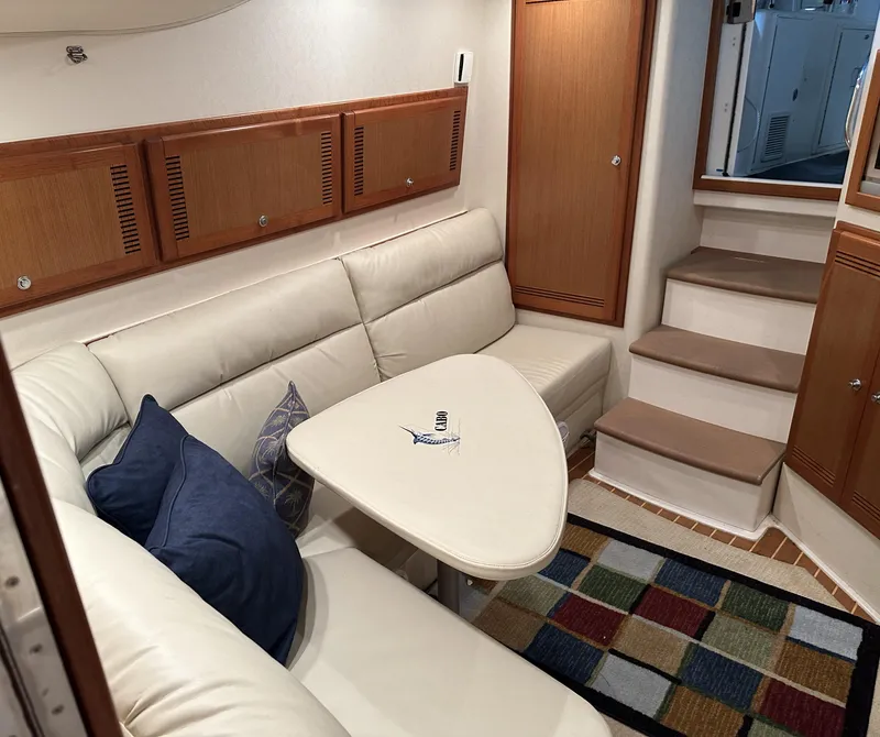 Slide: The Image of Interior of 2006 Cabo 40 Express yacht with beige seating and colorful rug. - 28
