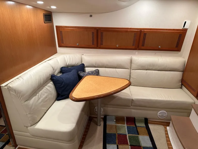 Slide: The Image of Luxurious 2006 Cabo 40 Express yacht interior with leather seating and wooden accents. - 29