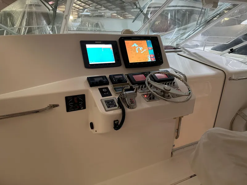 Slide: The Image of Control panel of a 2006 Cabo 40 Express boat with navigation screens. - 3