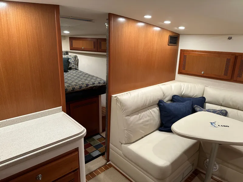 Slide: The Image of 2006 Cabo 40 Express yacht interior with cozy seating and modern wood finishes. - 35