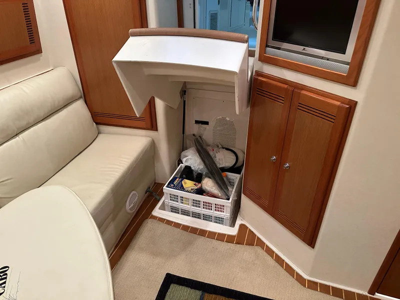 Slide: The Image of Interior of 2006 Cabo 40 Express yacht with storage compartment and seating area. - 39