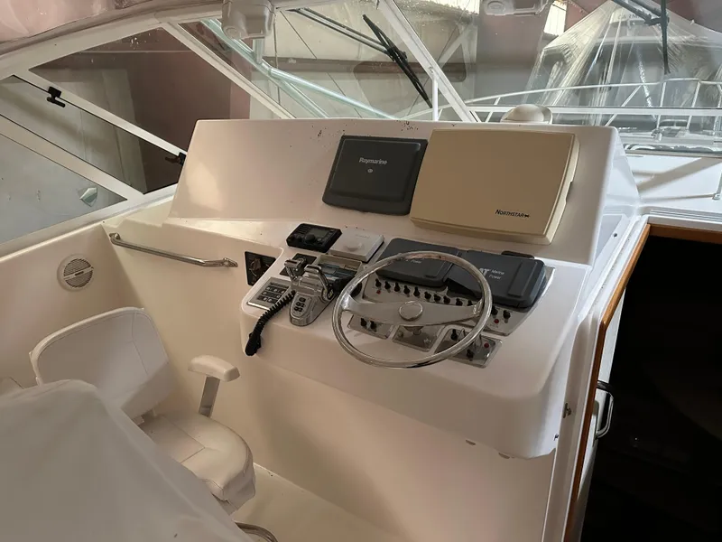 Slide: The Image of Helm of 2006 Cabo 40 Express boat with steering wheel and navigation equipment. - 7
