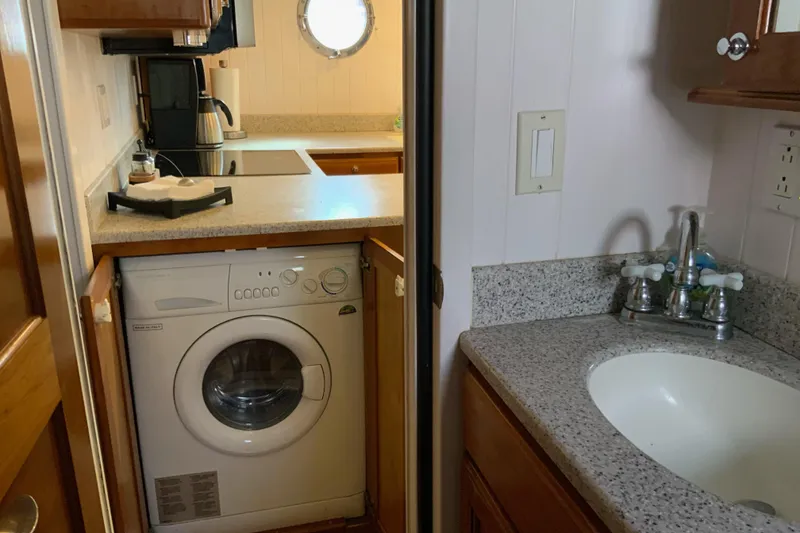 Slide: The Image of Compact kitchen and laundry area in 2008 Great Harbour N37 boat. - 14