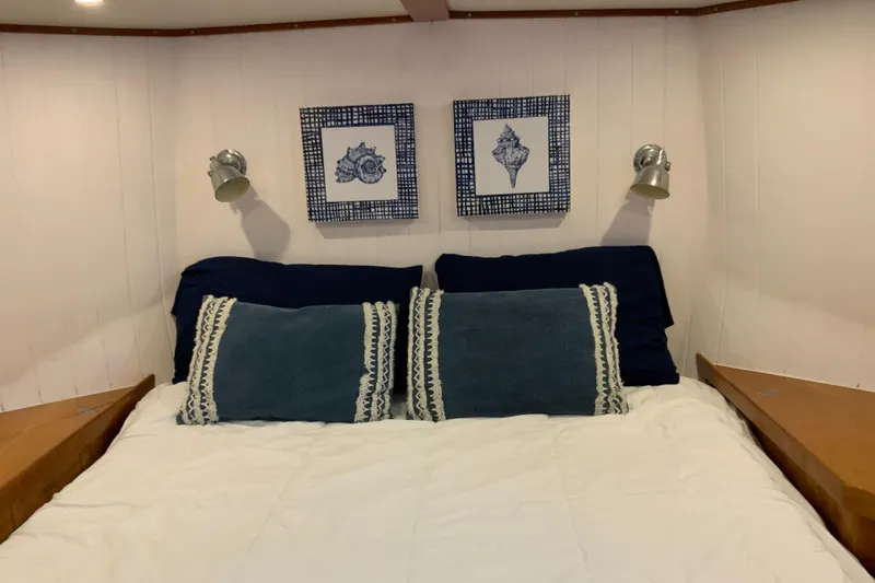 Slide: The Image of Cozy bedroom in 2008 Great Harbour N37 boat with nautical decor and twin reading lights. - 16