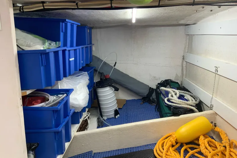 Slide: The Image of Storage area on a 2008 Great Harbour N37 boat with blue bins and nautical equipment. - 19