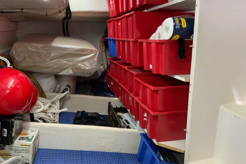Slide: The Image of Storage area on a 2008 Great Harbour N37 boat with organized red bins and nautical equipment. - 20