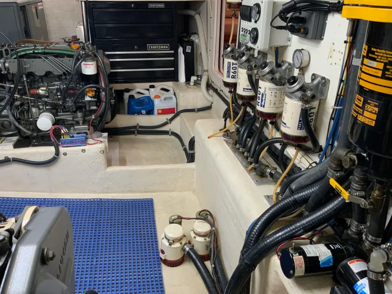 Slide: The Image of Engine room of 2008 Great Harbour N37 with mechanical components and tool storage. - 25