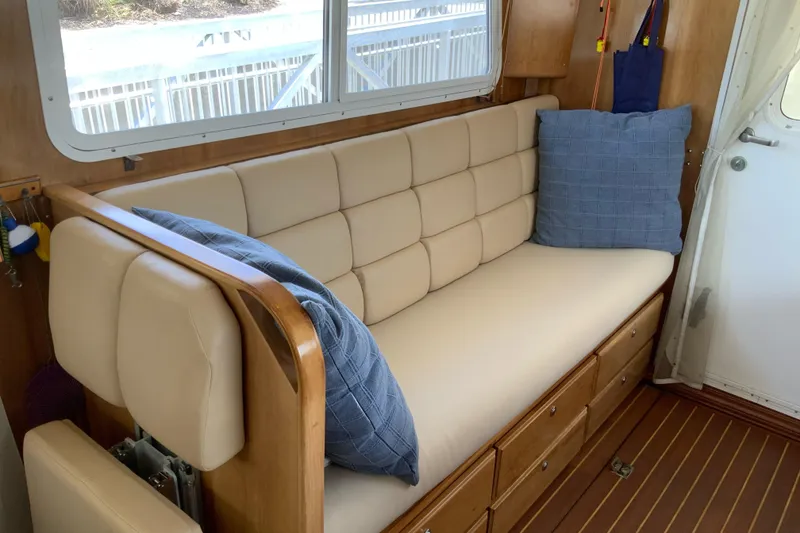 Slide: The Image of Interior of 2008 Great Harbour N37 with beige cushioned seating and blue pillows. - 4
