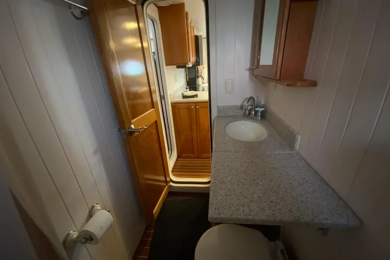 Slide: The Image of Bathroom interior of 2008 Great Harbour N37 yacht with sink and wooden cabinetry. - 8