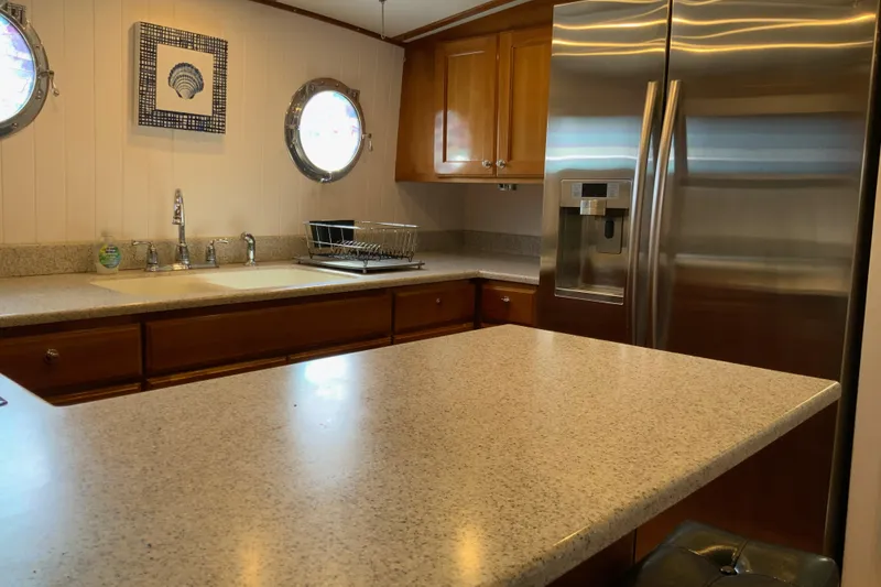 Slide: The Image of Kitchen interior of 2008 Great Harbour N37 yacht with modern appliances and porthole windows. - 9