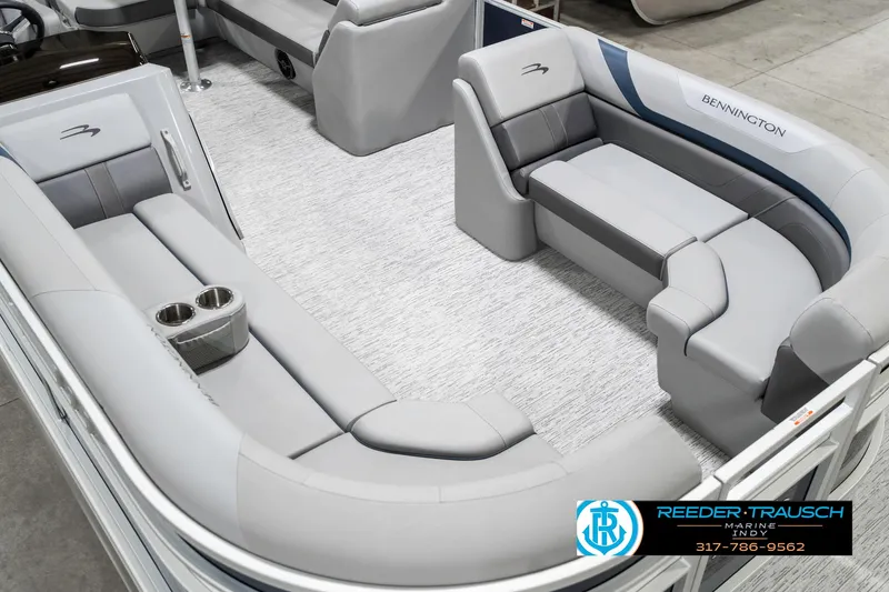 Slide: The Image of 2025 Bennington 22 SXL pontoon boat interior with plush gray seating and cup holders. - 13