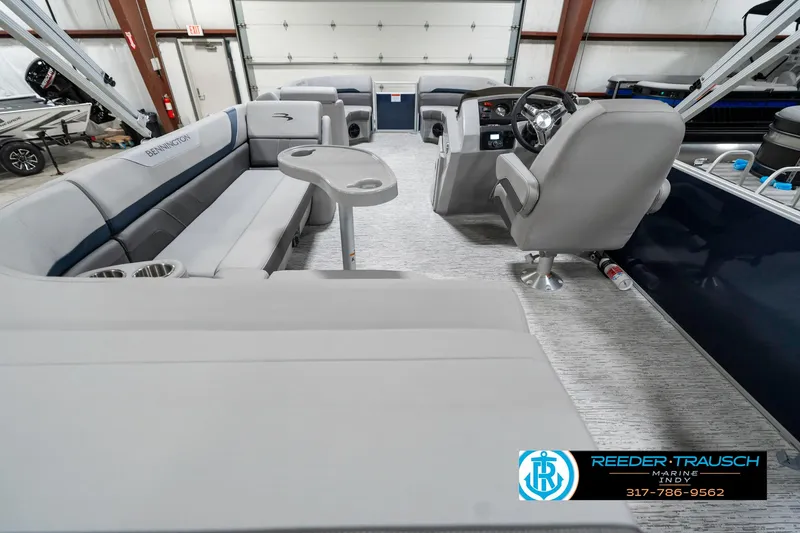 Slide: The Image of 2025 Bennington 22 SXL pontoon boat interior with plush seating and modern helm. - 19