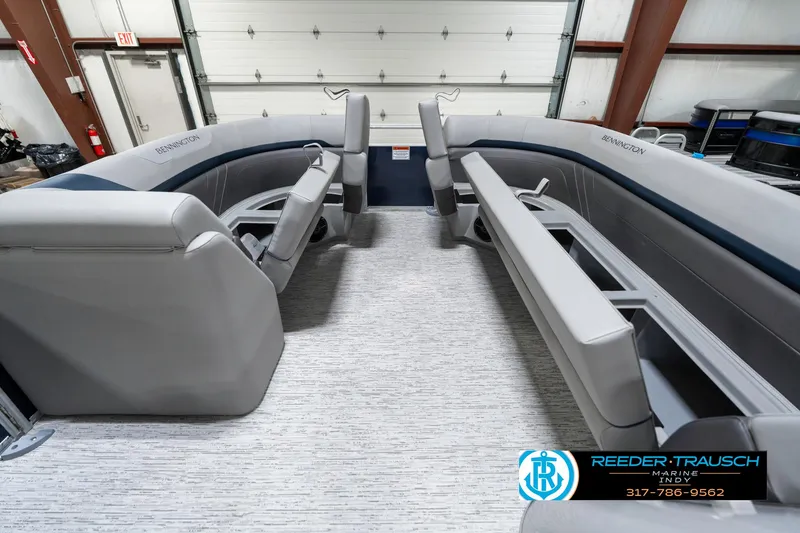 Slide: The Image of 2025 Bennington 22 SXL pontoon boat interior with gray seating and carpeted flooring. - 23