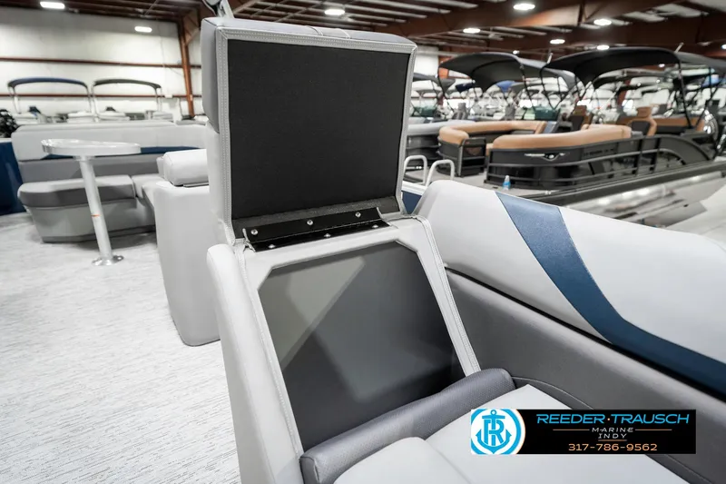 Slide: The Image of 2025 Bennington 22 SXL boat interior with open storage compartment, showcasing modern design. - 25