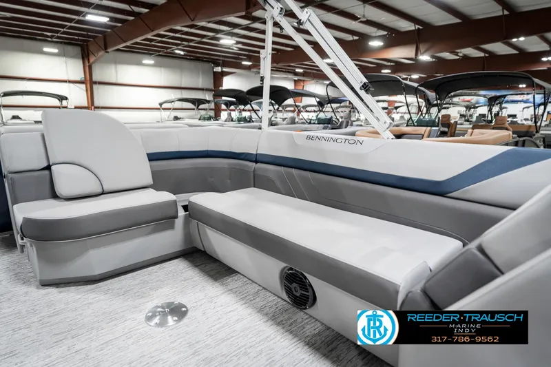 Slide: The Image of 2025 Bennington 22 SXL pontoon boat interior with gray seating in showroom. - 29
