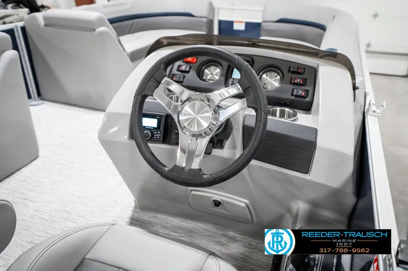 Slide: The Image of 2025 Bennington 22 SXL boat dashboard with steering wheel and control panel. - 32