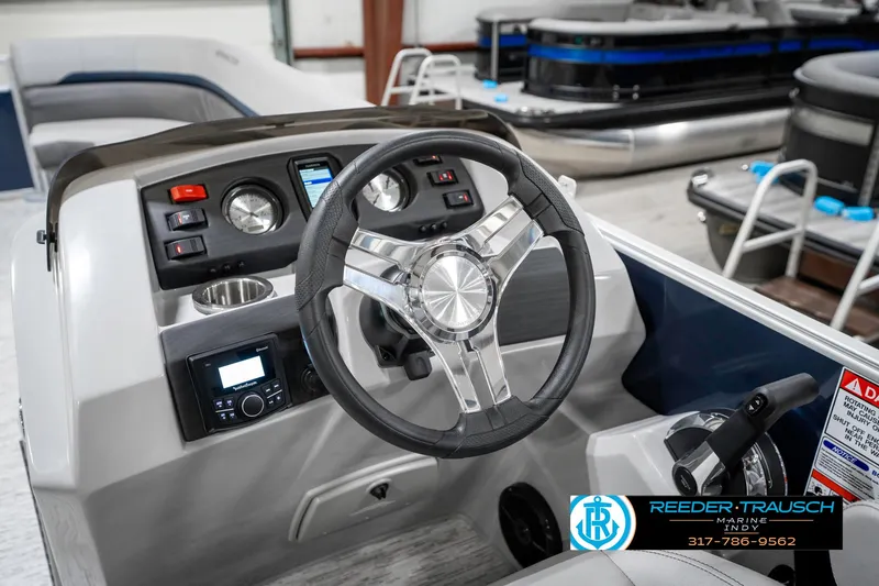 Slide: The Image of 2025 Bennington 22 SXL boat dashboard with steering wheel and control panel. - 33