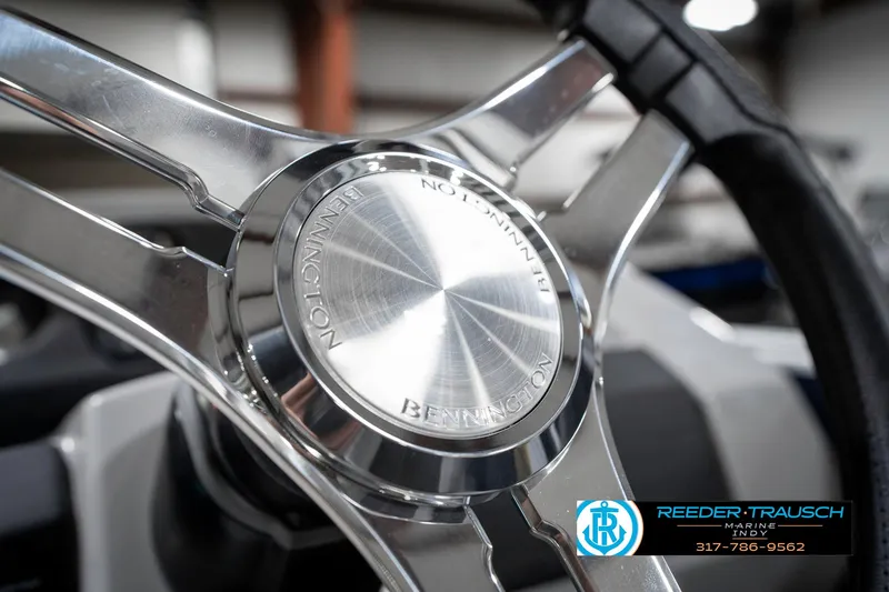 Slide: The Image of Steering wheel of 2025 Bennington 22 SXL boat, featuring sleek metallic design. - 34