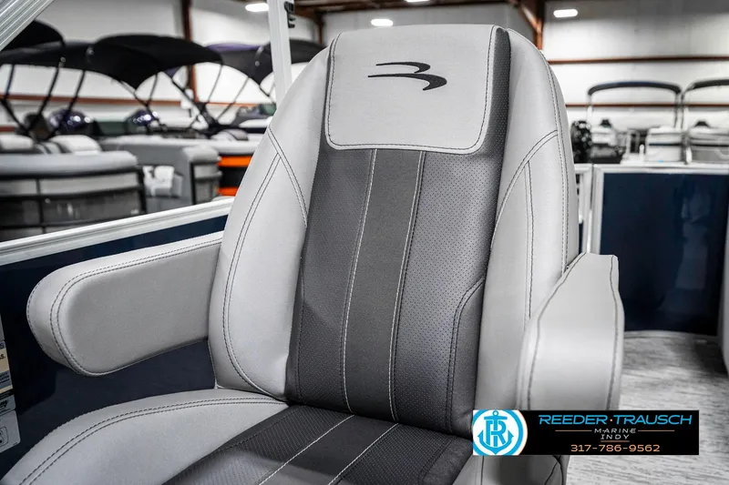 Slide: The Image of 2025 Bennington 22 SXL boat seat with sleek gray and black design in showroom. - 40