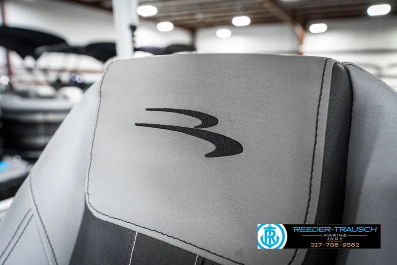 Slide: The Image of 2025 Bennington 22 SXL boat seat with logo in showroom setting. - 43