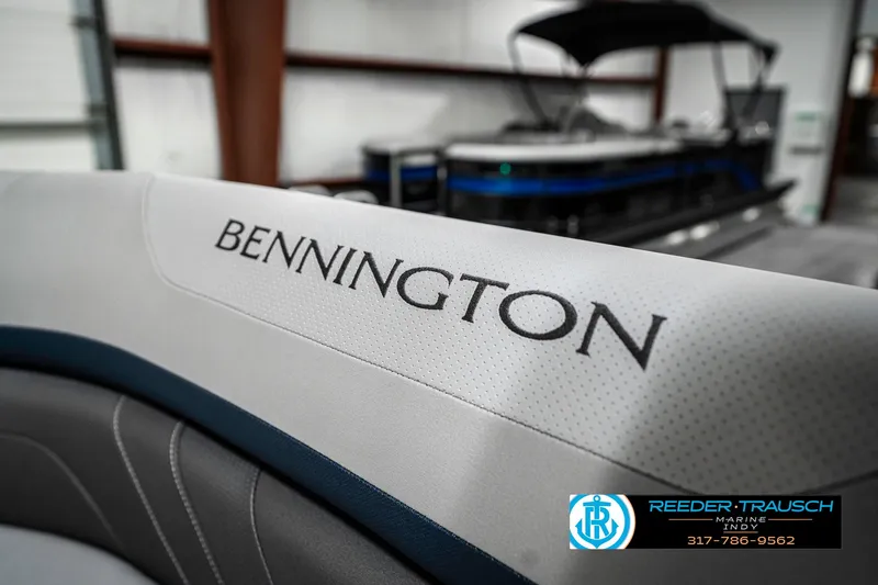 Slide: The Image of 2025 Bennington 22 SXL boat interior with logo, showcased in a showroom. - 44