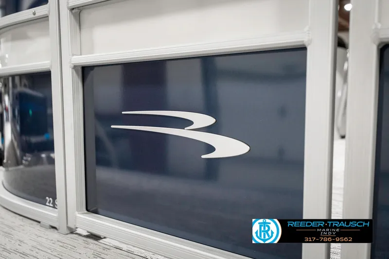 Slide: The Image of 2025 Bennington 22 SXL boat panel with logo, displayed at Reeder-Trausch Marine. - 48