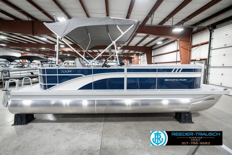 Slide: The Image of 2025 Bennington 22 SXL pontoon boat with canopy in showroom. - 7