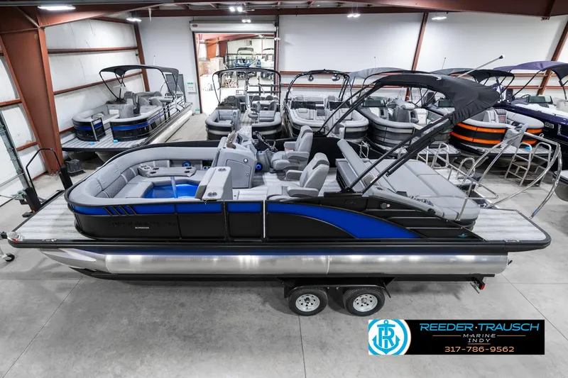 The Image of 2025 Bennington 23 LTSB pontoon boat in showroom, featuring sleek design and modern amenities. - 1