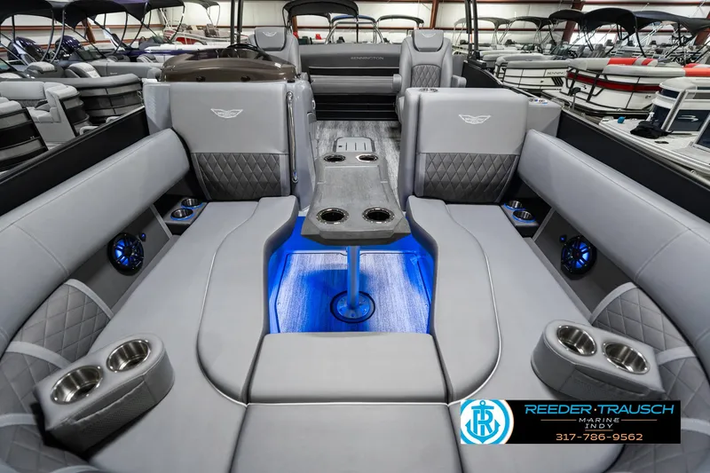 Slide: The Image of 2025 Bennington 23 LTSB boat interior with luxurious seating and blue LED lighting. - 16