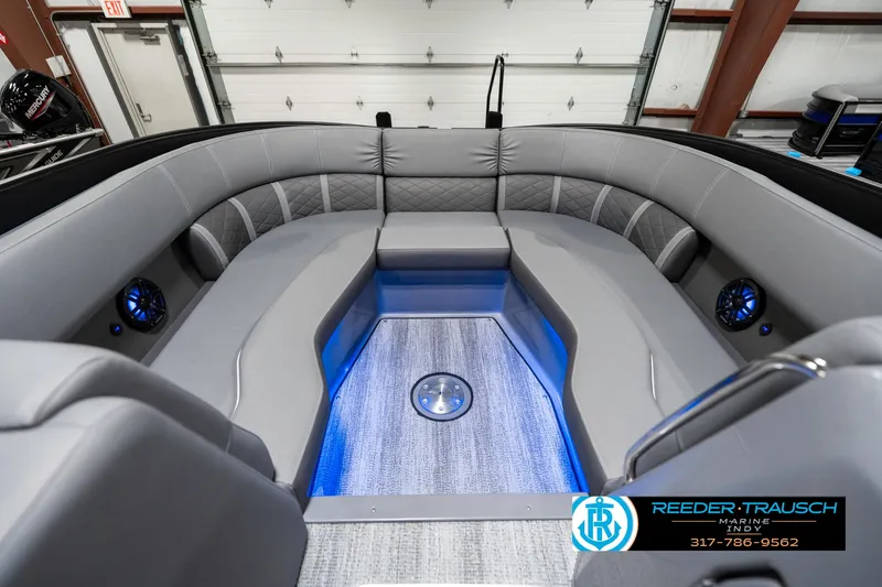 Slide: The Image of 2025 Bennington 23 LTSB boat interior with gray seating and blue LED lighting. - 23