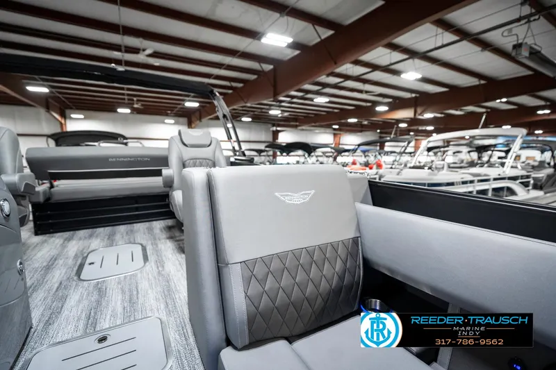 Slide: The Image of 2025 Bennington 23 LTSB pontoon boat interior with luxury seating in showroom. - 24