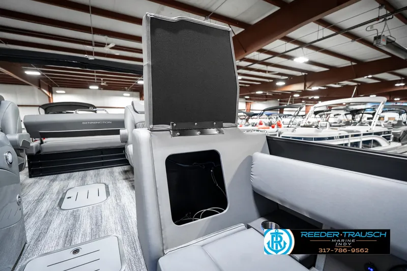Slide: The Image of 2025 Bennington 23 LTSB boat interior with open storage compartment in showroom. - 25