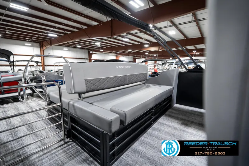 Slide: The Image of 2025 Bennington 23 LTSB pontoon boat interior with gray seating in showroom. - 26