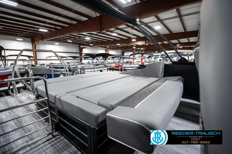 Slide: The Image of 2025 Bennington 23 LTSB pontoon boat interior with gray seating in showroom. - 28