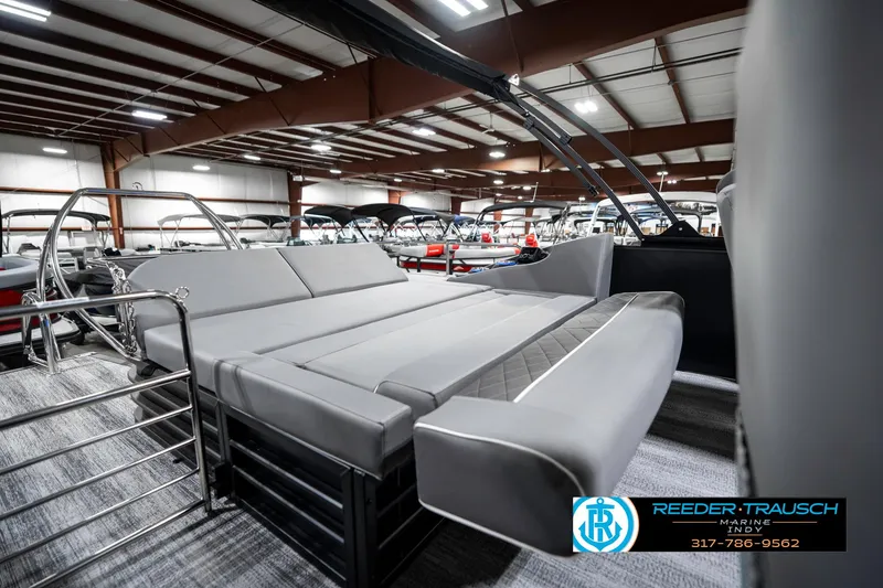 Slide: The Image of 2025 Bennington 23 LTSB pontoon boat interior with gray seating in showroom. - 29