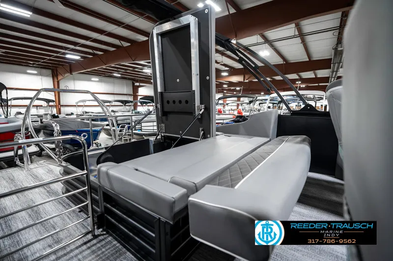 Slide: The Image of 2025 Bennington 23 LTSB pontoon boat interior with seating, displayed in a showroom. - 30