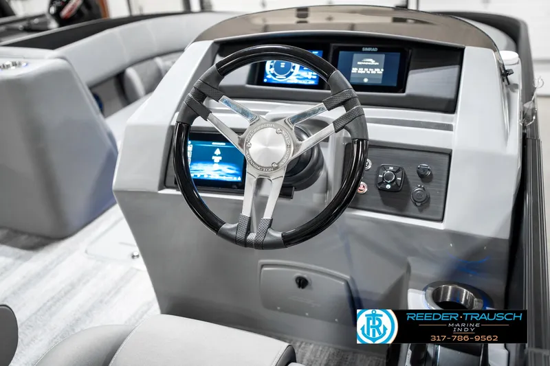Slide: The Image of 2025 Bennington 23 LTSB boat dashboard with modern steering wheel and digital displays. - 31