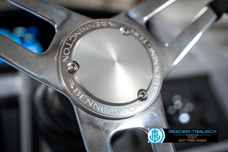 Slide: The Image of Steering wheel of 2025 Bennington 23 LTSB boat, featuring sleek metallic design. - 33