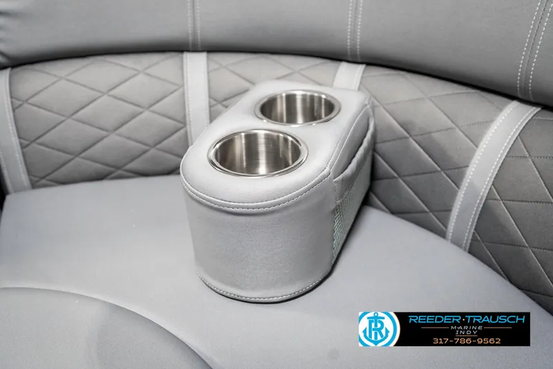 Slide: The Image of 2025 Bennington 23 LTSB boat interior with dual cup holders and quilted upholstery. - 47