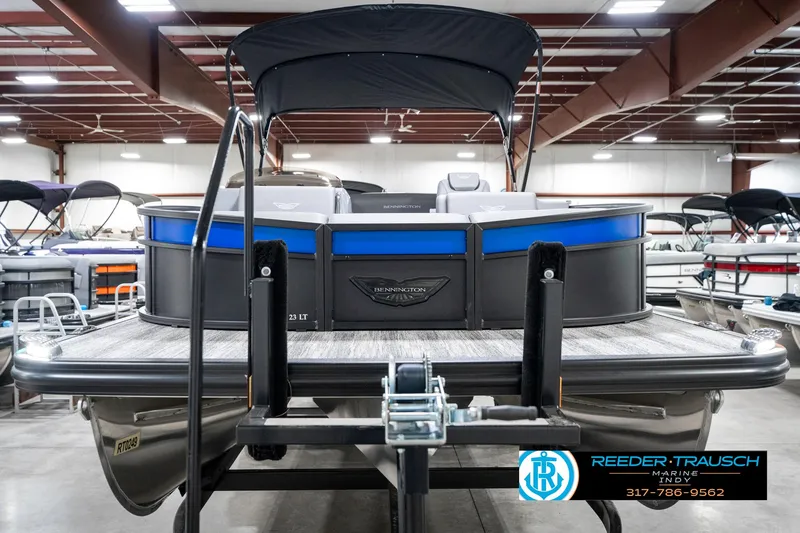 Slide: The Image of 2025 Bennington 23 LTSB pontoon boat in showroom, rear view with canopy. - 5