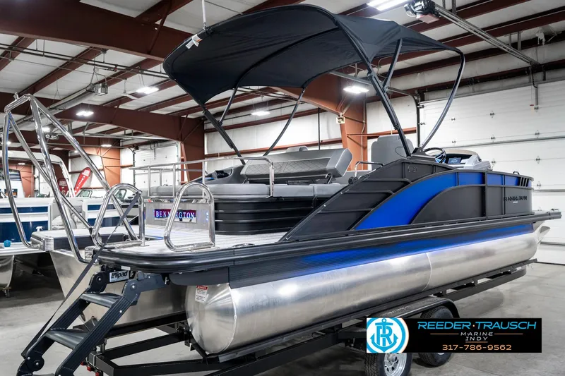 Slide: The Image of 2025 Bennington 23 LTSB pontoon boat in showroom with canopy and ladder. - 8